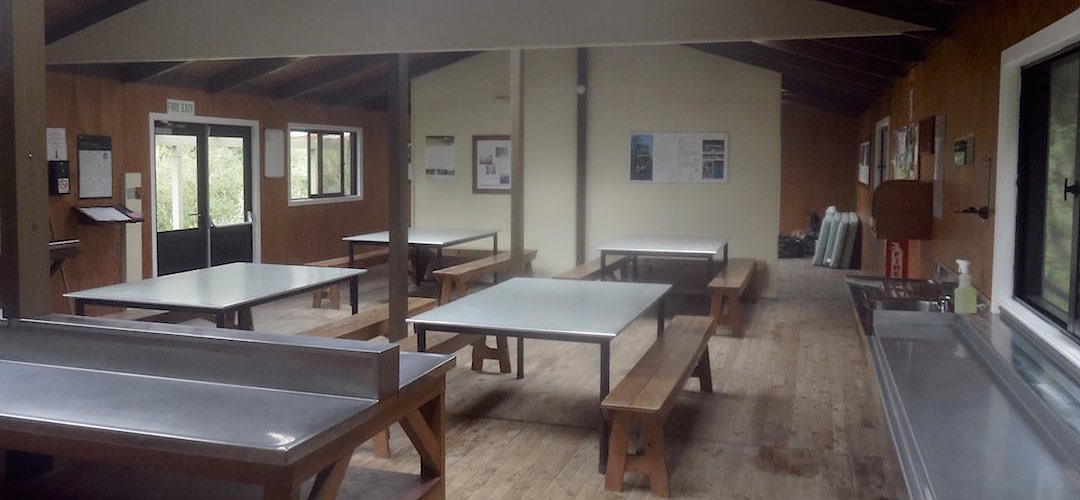 The kitchen/living area, the firebox is behind the partition.  | Dumpling Hut, Milford Track