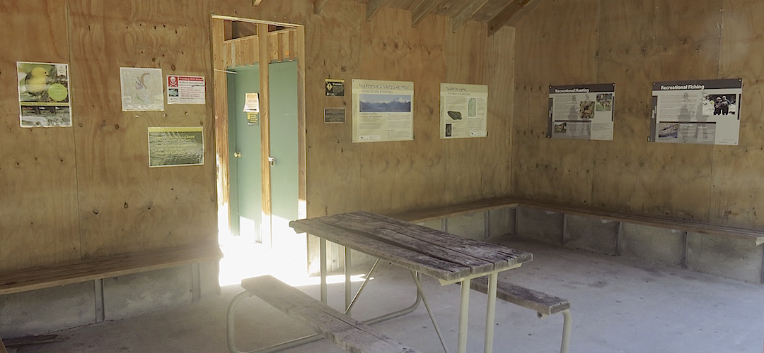 The three sided shelter has a summer flush toilet through there. | Greenstone shelter and carpark, Greenstone Track