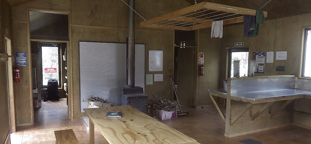 Standard firebox, two bunk rooms, decent bench space. | Greenstone Hut, Greenstone Track