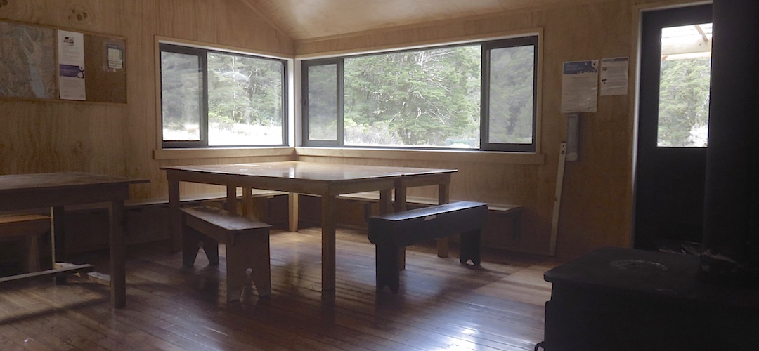 Three big tables with benches.  | McKellar Hut, Greenstone Track