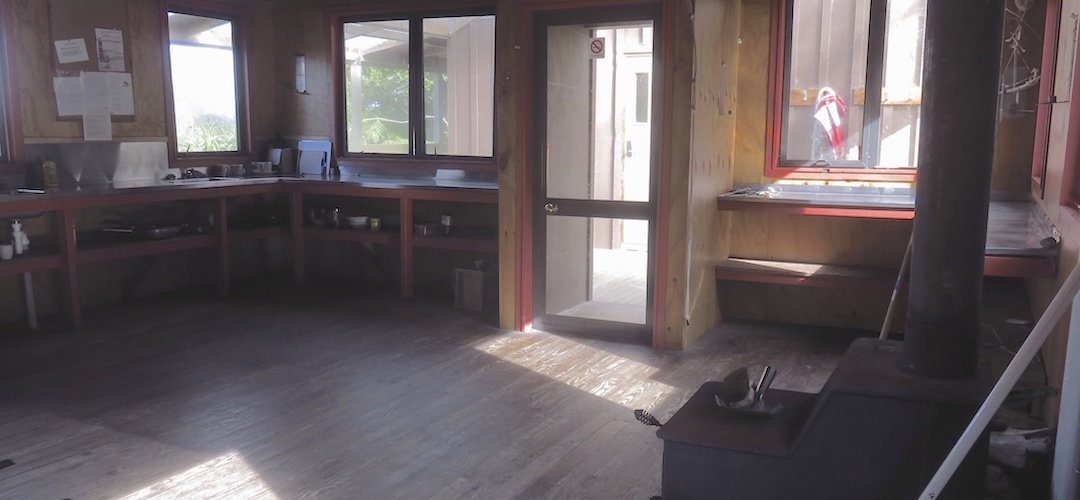 Plenty of benching in the kitchen area.   | Martins Bay Hut, Hollyford Track