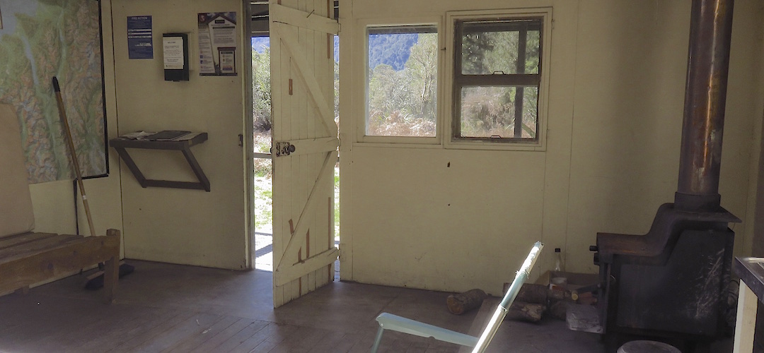 Standard issue firebox and a huge map.  | Olivine Hut, Pyke - Big Bay Route