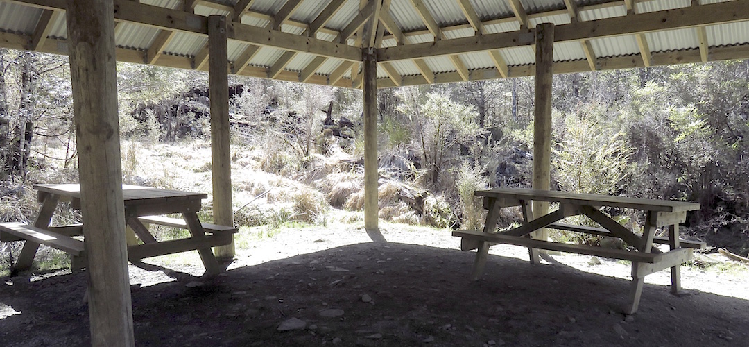 Roof with two picnic tables comes in handy when it, err, rains. | Rocky point shelter, Kepler Track