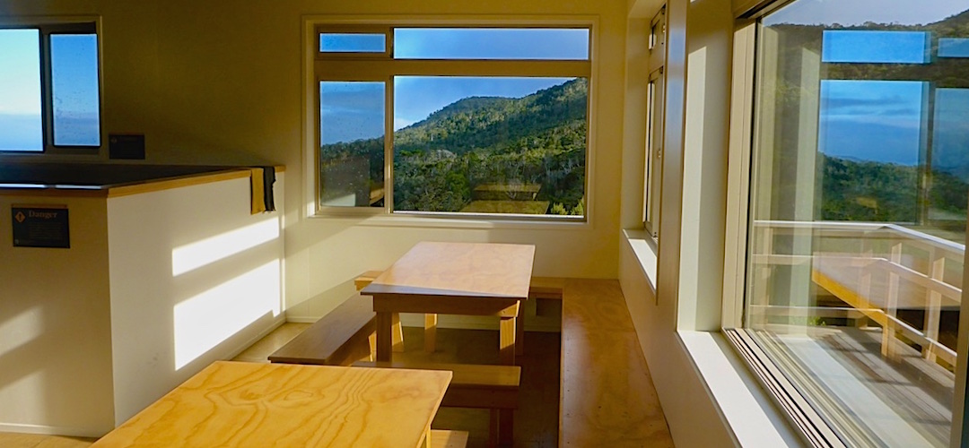 Living area with a view.  photo by David Guppy | James MacKay Hut, Heaphy Track, Kahurangi National Park