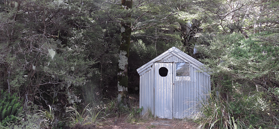 DOC has retained the historic structure. The waterfall is just out the back. I  Old Boulder Lake Hut, Kahurangi National Park