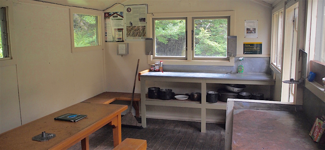 Plenty of rusty bench space, and windows. |  Helicopter Flat Hut, Kahurangi National Park