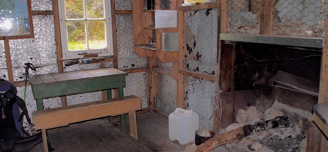 Many huts have had the open fireplaces removed and replaced with a firebox due to fire risk. | Wainui Hut, Abel Tasman National Park