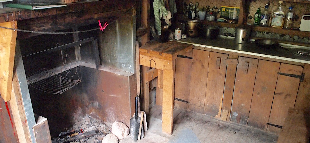 The restored fireplace and bench. | Goat Creek Hut, Mokihinui Forks Ecological Area