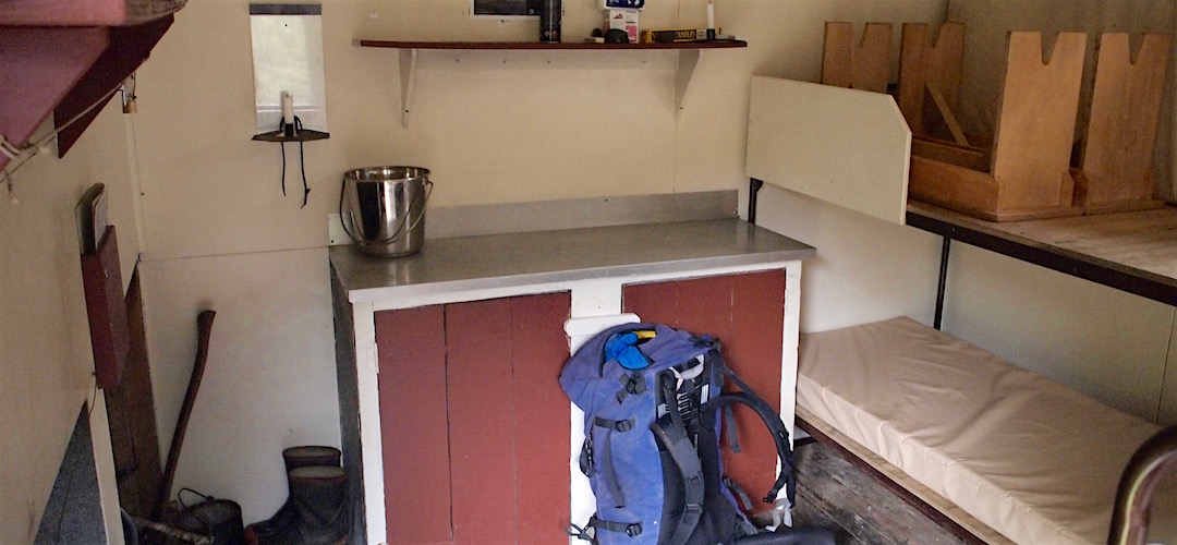 Aluminium bench, stainless bucket, steel bunks. | Hurricane Hut, Matiri River, Kahurangi National Park