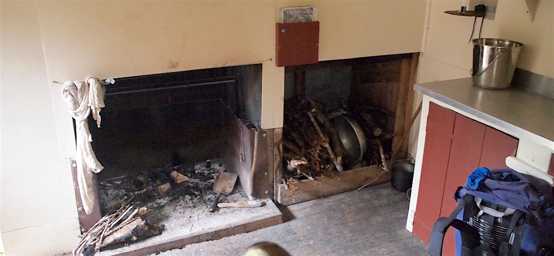 The open fire has a new steel guard. | Hurricane Hut, Matiri River, Kahurangi National Park