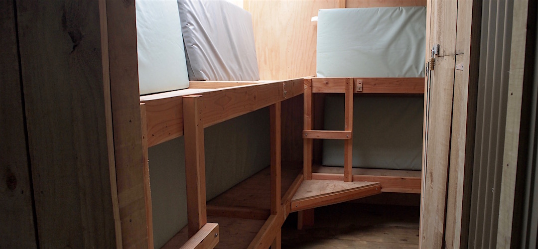 6 bunks are out on the porch. | Specimen Point Hut, Mohikinui Ecological Area