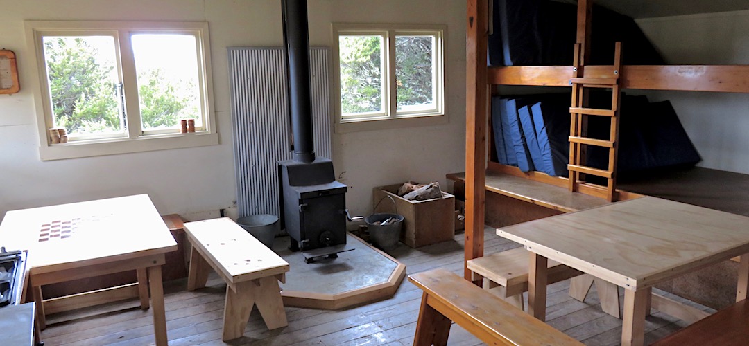 The wood burner has been recently installed by Waimea Tramping Club. | Balloon Hut, Kahurangi National Park
