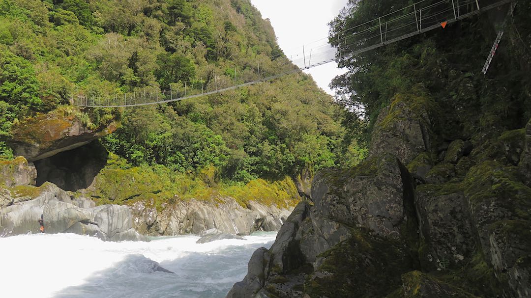 Swingbridge over a flooded Whitcombe River. |  Frew/Toaroha Saddles, Westland