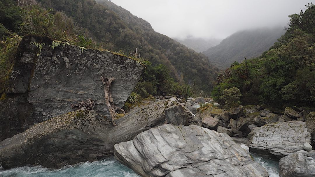 Toaroha River with a full sized tree cast up onto huge rocks. |  Frew/Toaroha Saddles, Westland