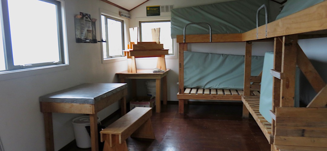 There's a bench and table, and six bunks. | Bluff Hut, Hokitika River, West Coast