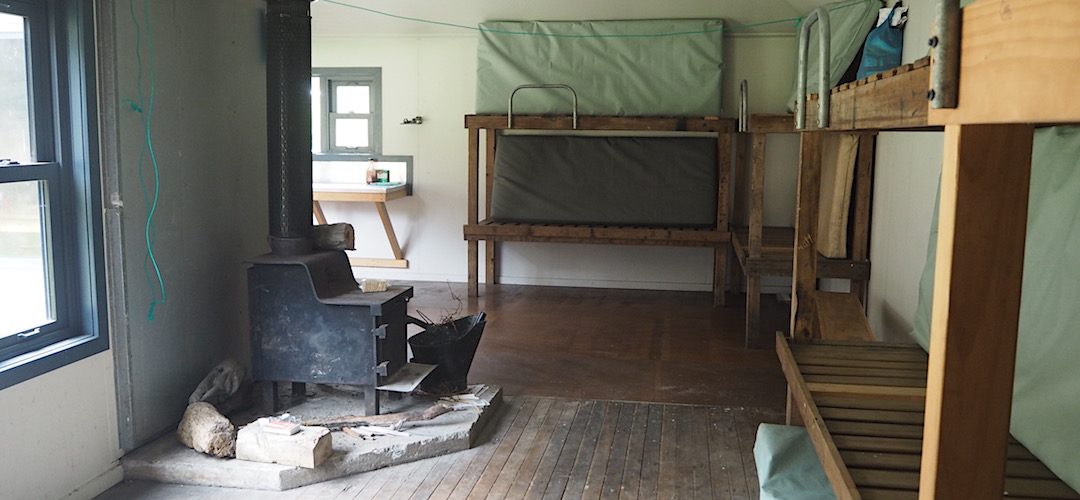 Standard wood burner and bunks. | Cedar Flats Hut, Toaroha River, West Coast