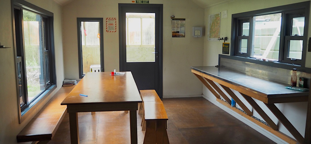 Great benching and table, away from the sleeping area. | Cedar Flats Hut, Toaroha River, West Coast