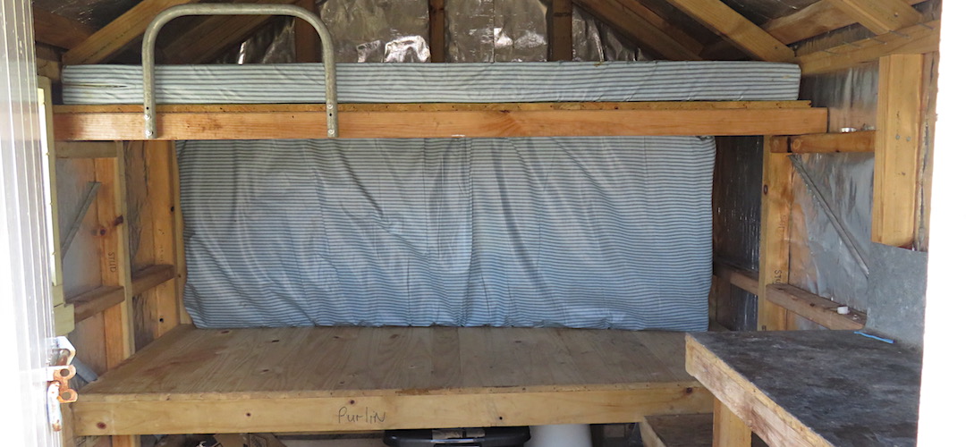 The mattress covers the end window. Tight top bunk. | Toaroha Saddle Bivvy, Toaroha River, West Coast