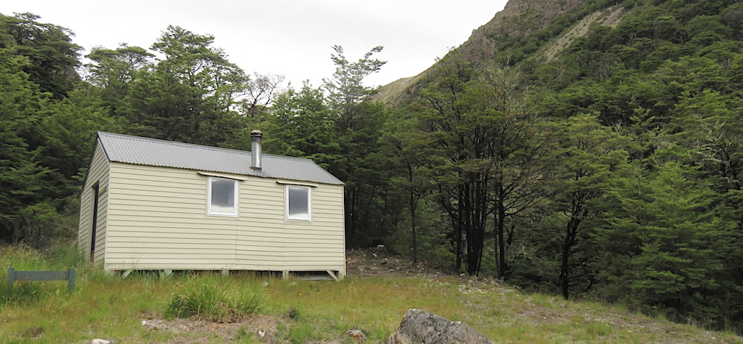 Top Gordon Hut is on a grassy, high river terrace. | Top Gordon Hut, Gordon Stream