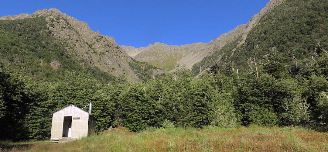 Top Leatham Hut is in an impressive landscape with the waterfall stream not far away.| Top Leatham Hut, Leatham River