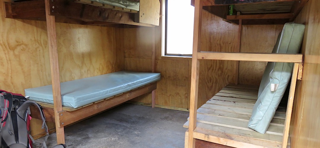 Fairly spartan interior with four comfy enough bunks. | Scotties Hut, St James Cycleway