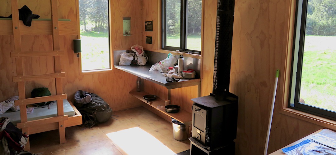 Tiny wood burner will keep the hut warm enough in winter due to double glazing and massive insulation. | Waiau Hut, Waiau River, Te Araroa