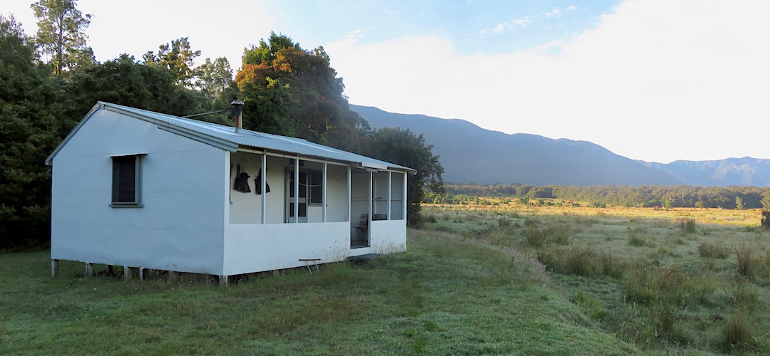 Hills in the background. Mosquitos in abundance. | Coppermine Creek Hut, Haast Paringa Cattle Trail