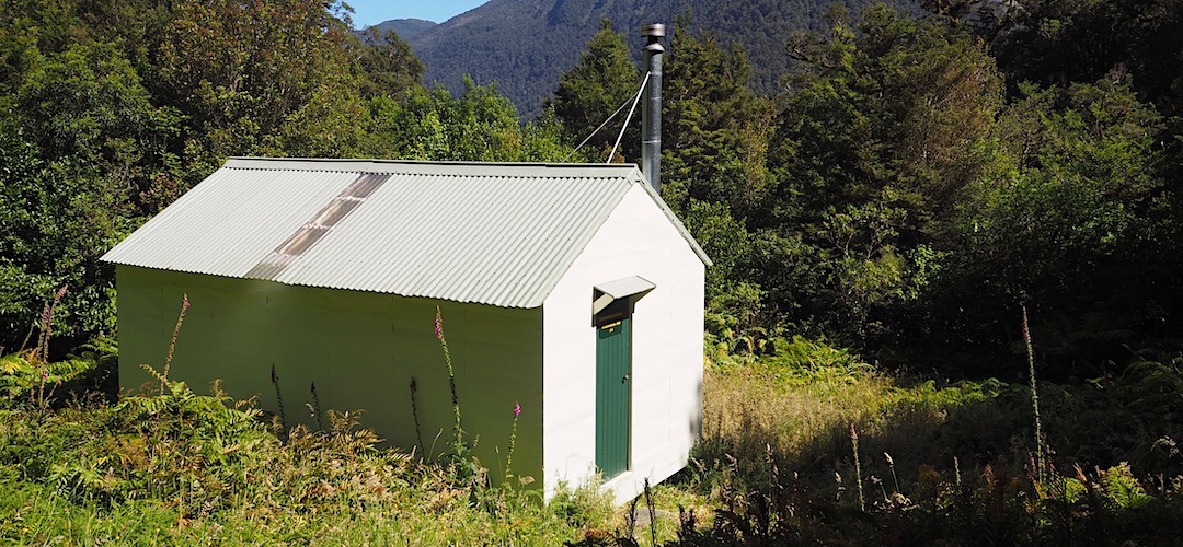 The open fire has recently been replaced by a wood burner. | Middle Head Hut, Moeraki Valley Trail