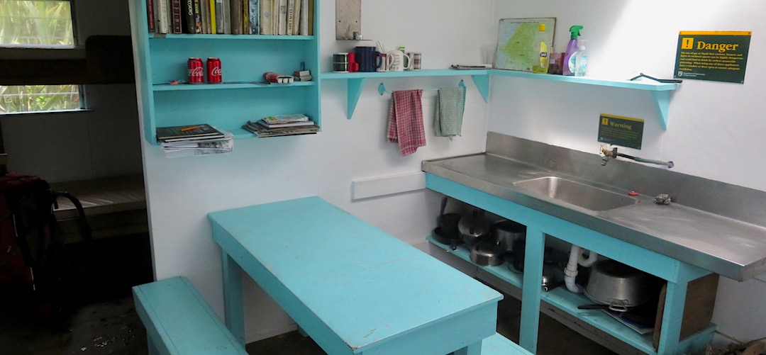 Kitchen/living. Bit of a library for rainy days. | Gorge River Hut, Barn Bay to Big Bay coastal route