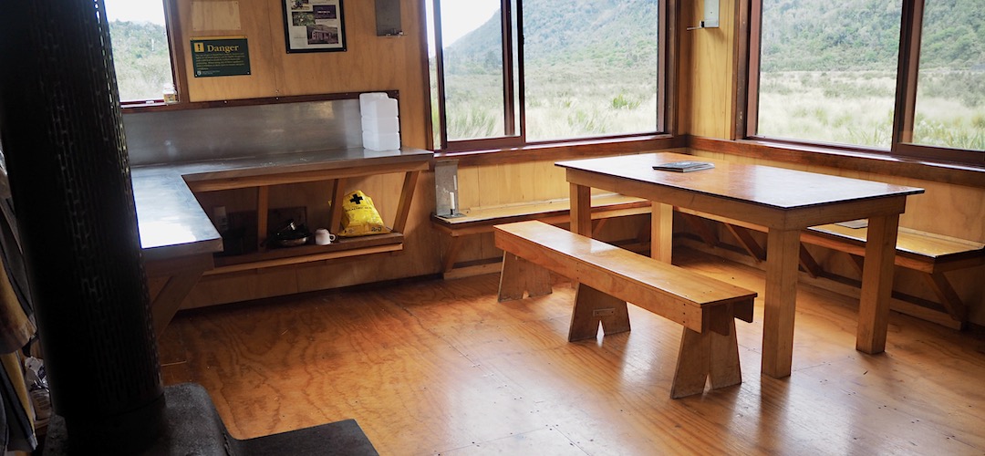 Plenty of window to look out and allow sunlight to flood in.  | Grassy Flat Hut, Styx River, West Coast