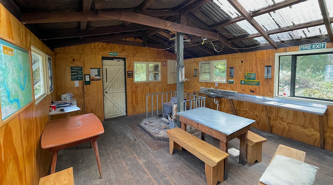 Wood burner and kitchen area. | Monowai Hut