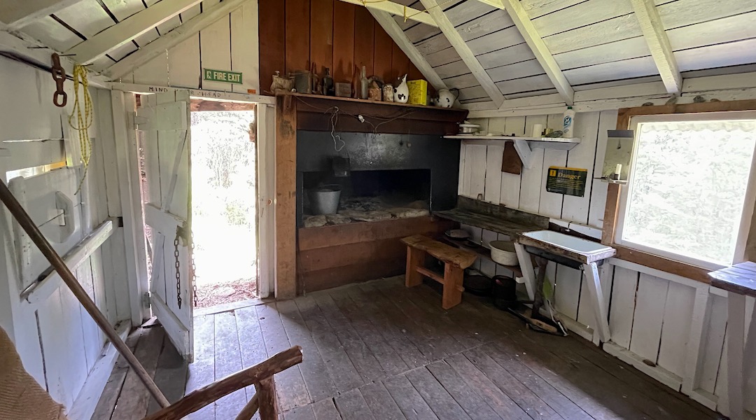 Renovated kitchen and fire. | Asbestos Cottage, Kahurangi National Park