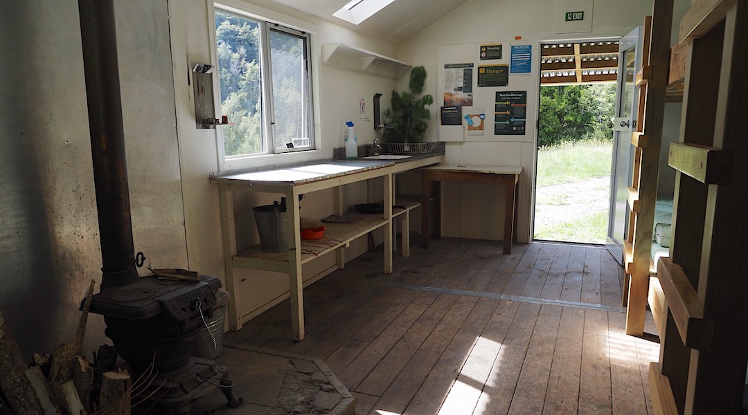The kitchen bench is original with a sink and tap. | Barber Hut, South Marlborough