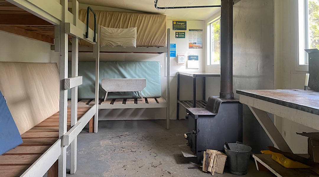 Concrete floor, large wood burner. | New Boulder Forks Hut, South Marlborough