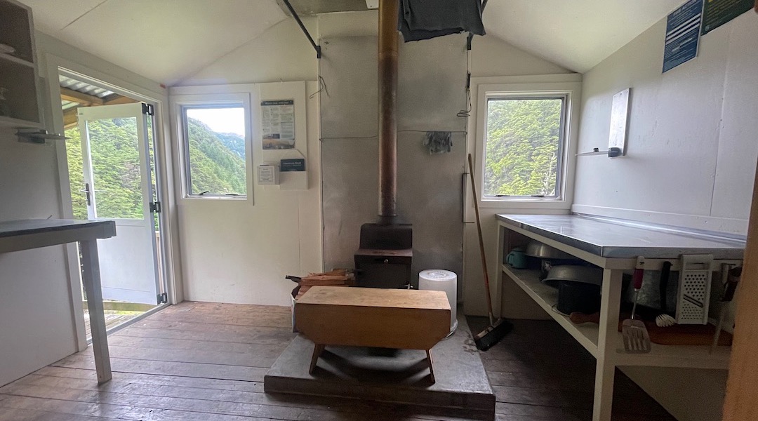 Neatly renovated interior with flyscreens that mostly keep the sandflies out.  |  Bottom Misery Hut, Branch River, Marlborough