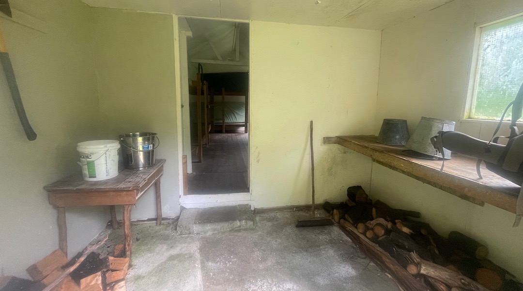 A big porch for storing firewood, and packs. |  Siberia Hut, Branch River, Marlborough