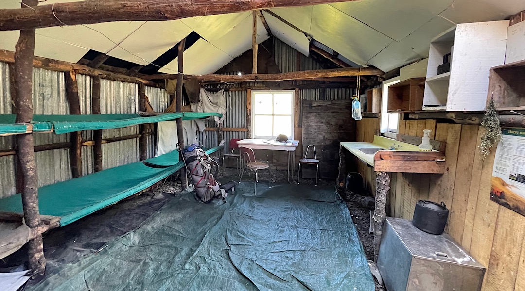 The dirt floor is covered with a woven plastic sheet. | Urquhart's Hut, Craigieburn Forest Park