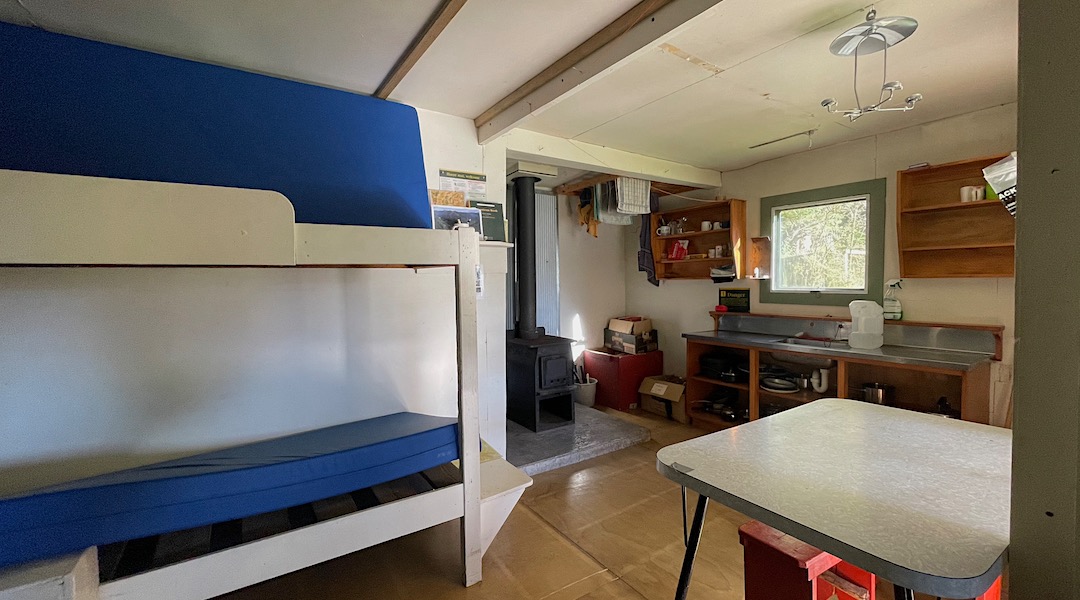 Kitchen and woodburner. | Roaring Lion Hut, Kahurangi National Park