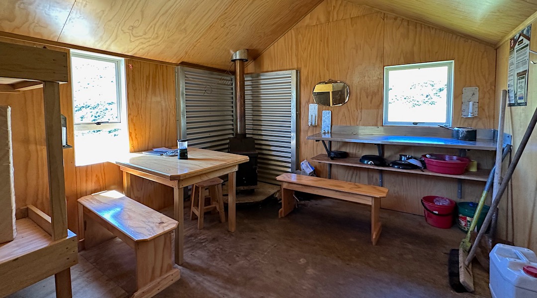 Kitchen bench & woodburner. No wood around though. | Otamatapaio Hut, Oteake Conservation Park