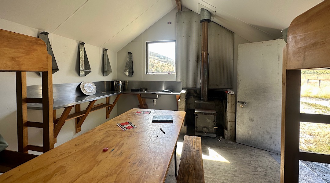 Kitchen bench and wood burner. | Boundary Creek Hut, Oteake Conservation Park