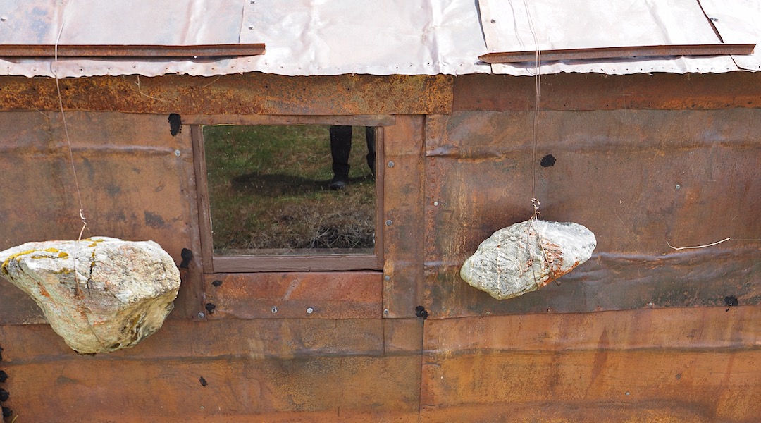 Rocks hold the roof down. | Jean Hut, Whakaari Conservation Area