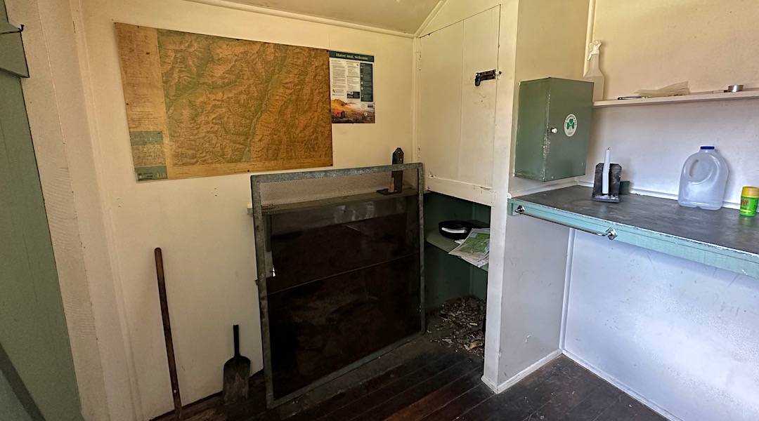 Fireplace & screen. | Shamrock Hut, Ahuriri Conservation Park