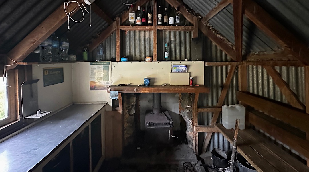 Kitchen bench and woodburner. | Spurs Hut, Te Kahui Kaupeka Conservation Park