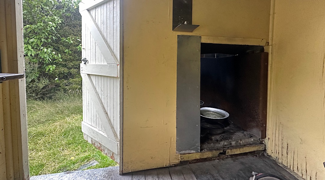 Fireplace with limited wood. | Forbes Bivvy, Te Kahui Kaupeka Conservation Park