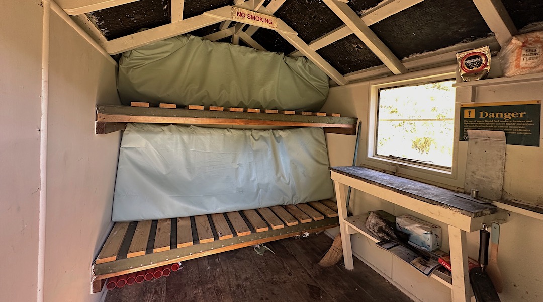 The original canvas bunks are overlaid with slats and a mattress. | Murphys Bivvy, Te Kahui Kaupeka Conservation Park
