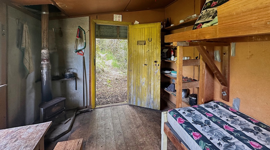 The woodburner is tiny, but a forest for firewood is adjacent to the hut. | Mt Malita Hut, Nelson City Council