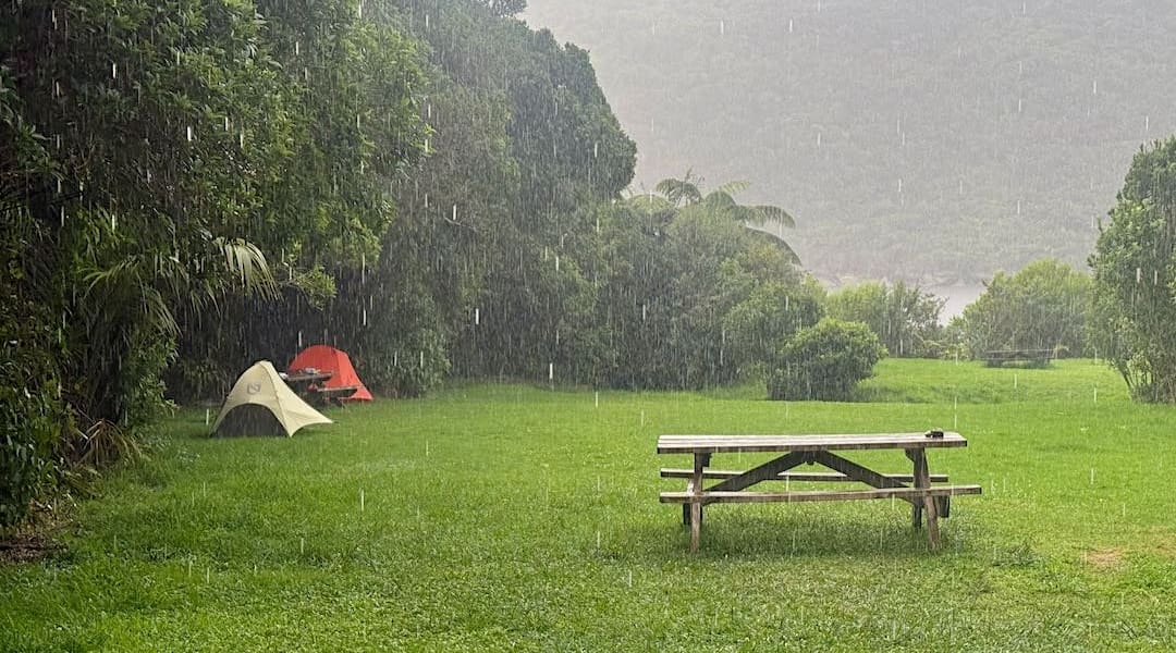 Rain coming down during dinner time. | Heaphy Hut campsite, Heaphy Track