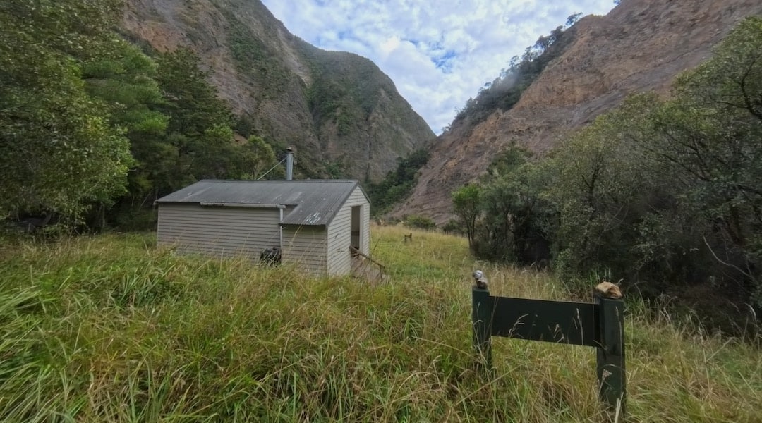 The hut is in a sunny spot at the head of Sawcut Gorge. | Isolation Hut, Isolated Hill Scenic Reserve