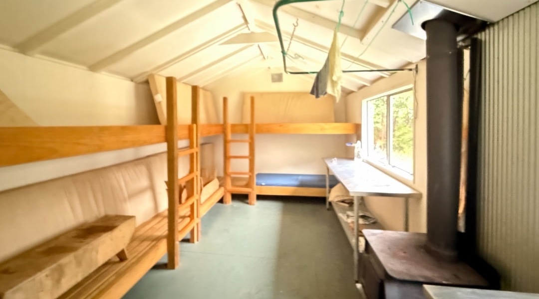 Interior bunks and stainless steel bench.| Isolation Hut, Isolated Hill Scenic Reserve