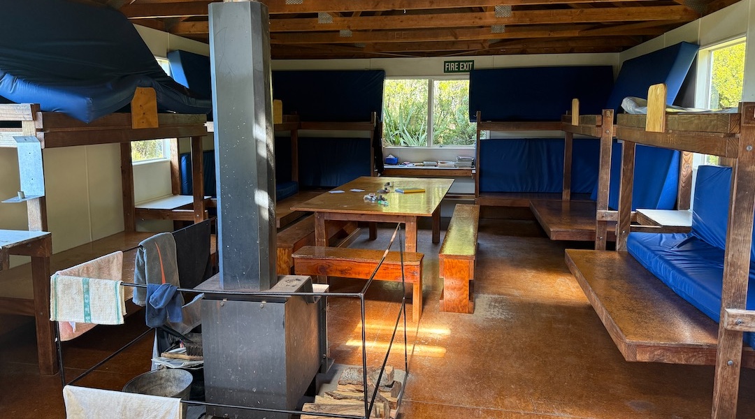 The wood burner keeps it cosy. | Pinnacles Hut, Hakatere Conservation Park